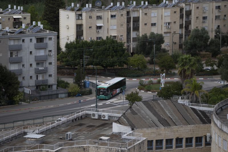 A bus drives on a street in Kiryat Shmona, a city located next to the border with Lebanon, northern Israel, Tuesday, Sept. 17, 2024. (AP Photo/Leo Correa)