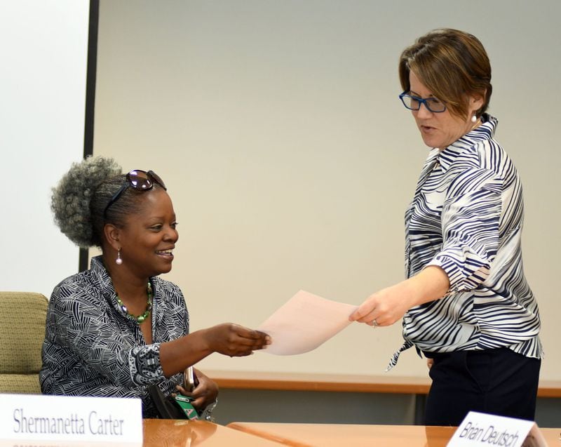 DeKalb County Board of Ethics member Shermanetta Carter (left) and Ethics Officer Stacey Kalberman talk before the DeKalb Board of Ethics meeting on August 1, 2017. 