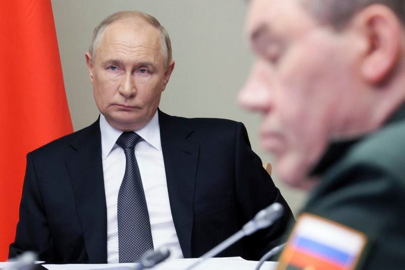 Russian President Vladimir Putin, left, leads the meeting with top security and defence officials dedicated to the situation in Kursk and Belgorod border regions, at Novo-Ogaryovo state residence outside of Moscow, Russia, Monday, Aug. 12, 2024. (Gavriil Grigorov, Sputnik, Kremlin Pool Photo via AP)