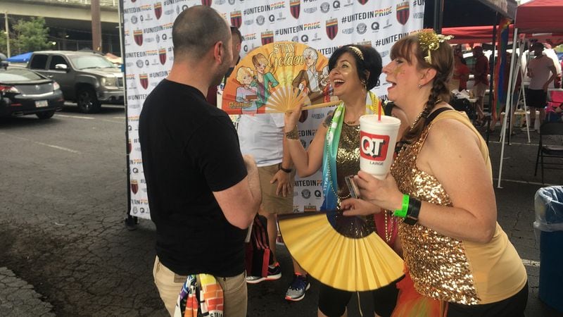 Sean Ellis, Terri Harrington and Angel Whitworth enjoy a laugh during a tailgate before the Atlanta United game June 29, 2019 at Mercedes-Benz Stadium. All Stripes is an Atlanta United supporter group for LGBTQ fans and their allies.