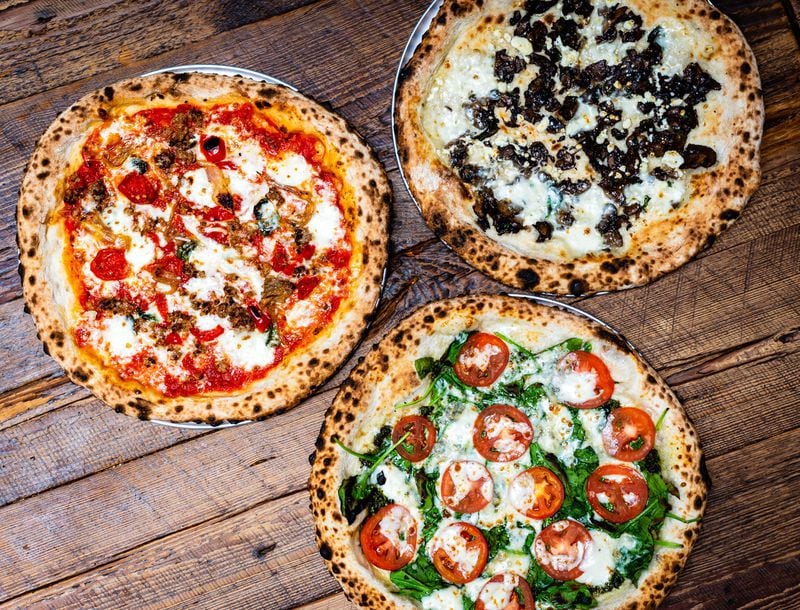 The pizzas at Ammazza on Edgewood Avenue include (clockwise from left) Amarena, Terra and Pesto Gorgonzola. CONTRIBUTED BY HENRI HOLLIS