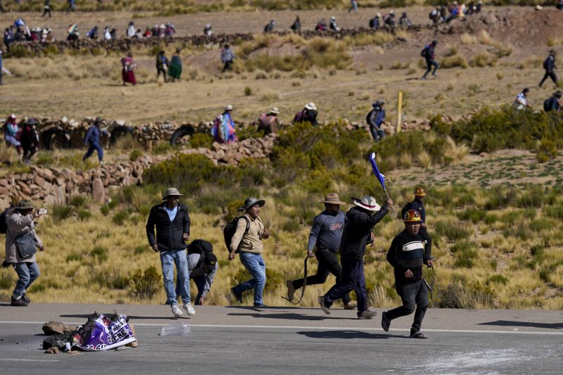 Supporters of former President Evo Morales, who are marching to the capital to protest the government of current President Luis Arce, advance towards Arce supporters who met them along their route in Vila Vila, Bolivia, Tuesday, Sept. 17, 2024. (AP Photo/Juan Karita)