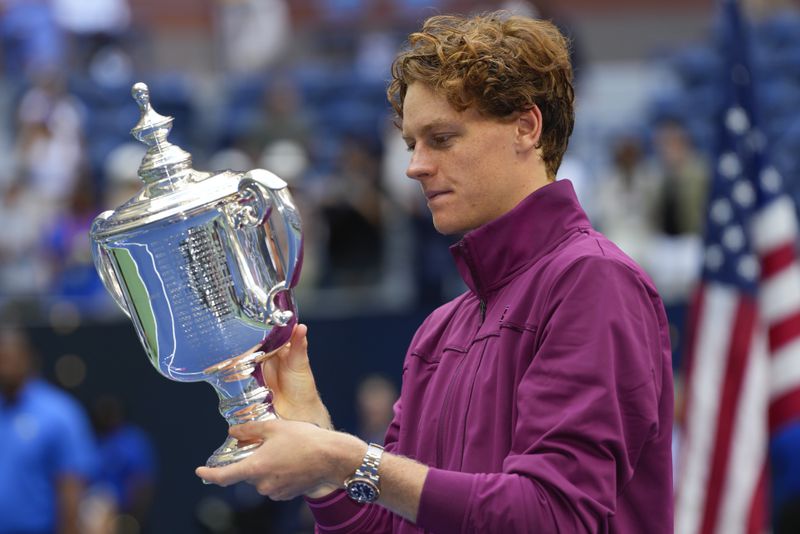 Jannik Sinner, of Italy, holds the championship trophy after defeating Taylor Fritz, of the United States, in the men's singles final of the U.S. Open tennis championships, Sunday, Sept. 8, 2024, in New York. (AP Photo/Kirsty Wigglesworth)