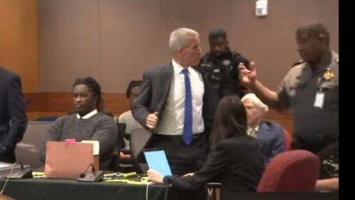 Brian Steel, attorney for rapper Young Thug, removes his suit jacket and tie before heading to a short stint in lockup after being found in contempt of court.