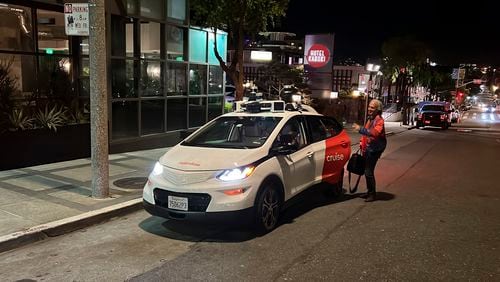 FILE - Associated Press reporter Michael Liedtke gets out of a Cruise driverless taxi after a test ride in San Francisco, on Feb. 15, 2023. (AP Photo/Terry Chea, File)