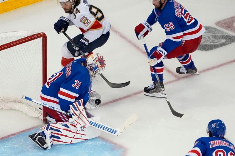 New York Rangers goaltender Igor Shesterkin (31) makes a save on a shot by Florida Panthers left wing Ryan Lomberg (94) in overtime of Game 2 of the Eastern Conference finals during the NHL hockey Stanley Cup playoffs, Friday, May 24, 2024, in New York. (AP Photo/Julia Nikhinson)