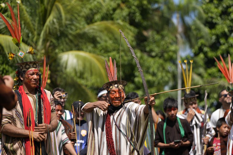 Ashaninka Indigenous Antonio Piyako, center, participates in a bow and arrow competition during the annual celebration recognizing the Ashaninka territory in the Apiwtxa village, Acre state, Brazil, Sunday, June 23, 2024. (AP Photo/Jorge Saenz)