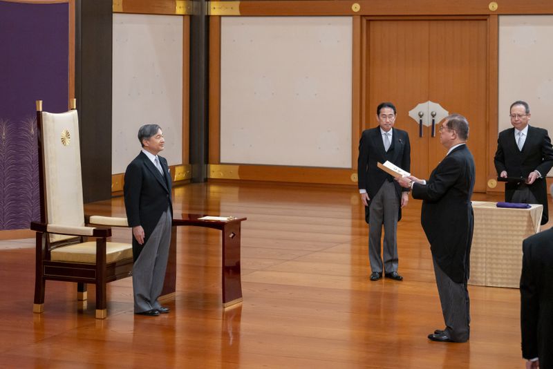 In this photo provided by Japan's Imperial Household Agency of Japan, Japan's Emperor Naruhito, left, stands before new Prime Minister Shigeru Ishiba, right, as former Prime Minister Fumio Kishida, third right, looks on during Ishiba's formal appointment ceremony at the Imperial Palace in Tokyo, Tuesday, Oct. 1, 2024. (Imperial Household Agency of Japan via AP)