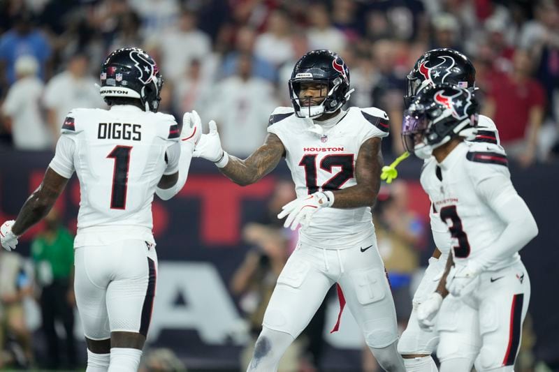 Houston Texans wide receiver Nico Collins (12) is congratulated by Stefon Diggs (1) after catching a touchdown pass during the first half of an NFL football game against the Chicago Bears Sunday, Sept. 15, 2024, in Houston. (AP Photo/Eric Christian Smith)