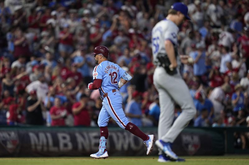 Philadelphia Phillies' Kyle Schwarber, left, rounds the bases after hitting a home run against Los Angeles Dodgers pitcher Ryan Yarbrough during the eighth inning of a baseball game, Thursday, July 11, 2024, in Philadelphia. (AP Photo/Matt Slocum)