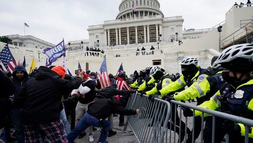 Insurrectionists loyal to then-President Donald Trump try to break through a police barrier at the U.S. Capitol in Washington on Jan. 6, 2021. (AP Photo/Julio Cortez, File)