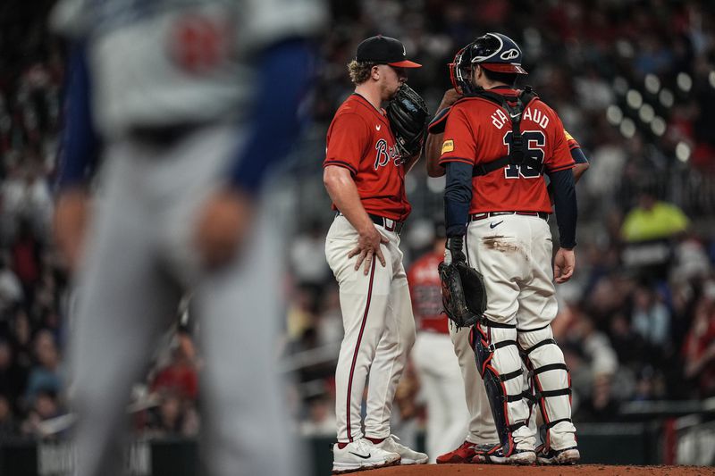 Atlanta Braves pitcher Spencer Schwellenbach (56) speaks with catcher Travis d'Arnaud on the mound in the fourth inning of a baseball game against the Los Angeles Dodgers, Friday, Sept. 13, 2024, in Atlanta. (AP Photo/Mike Stewart)