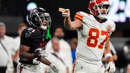 Kansas City Chiefs tight end Travis Kelce (87) celebrates a catch against Atlanta Falcons cornerback Mike Hughes (21) during the second half of an NFL football game, Sunday, Sept. 22, 2024, in Atlanta. (AP Photo/Brynn Anderson)