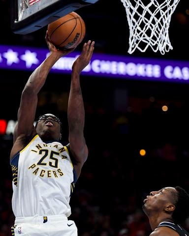 Indiana Pacers forward Jalen Smith (25) makes a shot as Atlanta Hawks forward Onyeka Okongwu (17) looks on during the first half of an NBA game Tuesday, November 21, 2023 at State Farm Arena. (Daniel Varnado/For the AJC)