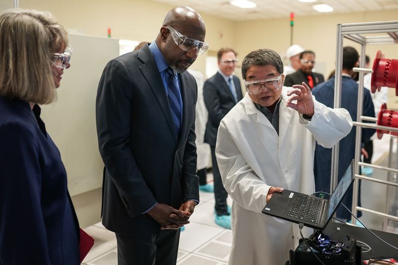 U.S. Sen. Raphael Warnock, D-Ga., learns about fiber optic manufacturing process during a visit to the OFS fiber optic cable manufacturing facility on Friday, May 10, 2024, in Norcross. (Elijah Nouvelage for The Atlanta Journal-Constitution)