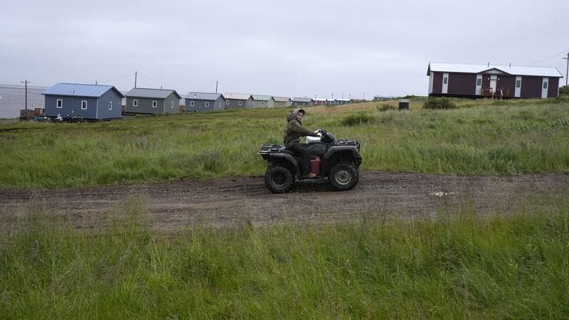 A young man drives an ATV on Friday, Aug. 16, 2024, Mertarvik, Alaska. (AP Photo/Rick Bowmer)