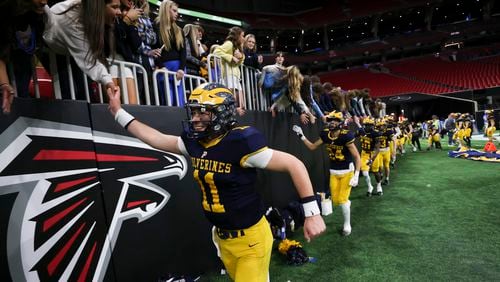 Prince Avenue Christian quarterback Aaron Philo (11) celebrates with fans after their 49-32 win against Swainsboro in the Class A Division I GHSA State Championship game at Mercedes-Benz Stadium, Monday, December. 11, 2023, in Atlanta. (Jason Getz / Jason.Getz@ajc.com)