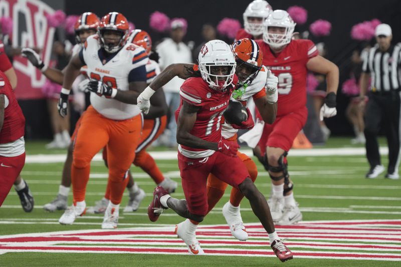 UNLV wide receiver Ricky White III (11) runs after a catch in the first half during an NCAA college football game against Syracuse, Friday, Oct. 4, 2024, in Las Vegas. (AP Photo/Rick Scuteri)