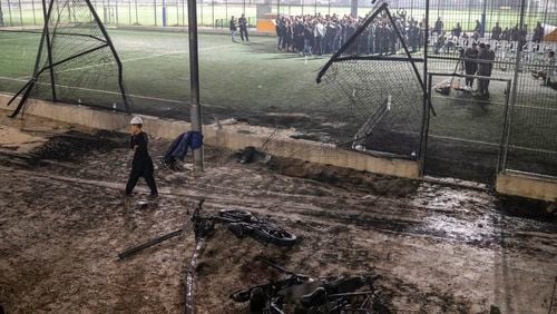 FILE - A boy walks past bicycles left next to a soccer pitch that was hit by a rocket, killing 12 children and teenagers, in the Druze town of Majdal Shams, in the Israeli-annexed Golan Heights, Saturday, July 27, 2024. Two days after the attack questions remain about why it happened and who is responsible. (AP Photo/Leo Correa, File)