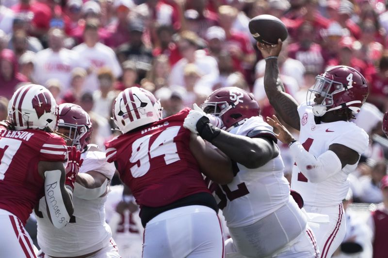 Alabama's Jalen Milroe (4) thorws a touchdown pass during the first half of an NCAA college football game against Wisconsin Saturday, Sept. 14, 2024, in Madison, Wis. (AP Photo/Morry Gash)