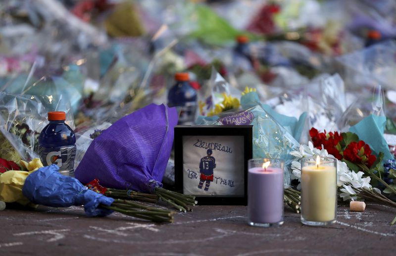 Fans leave mementos as part of the candlelight vigil to honor Columbus Blue Jackets hockey player Johnny Gaudreau, Thursday, Sept. 4, 2024, outside of Nationwide Arena in Columbus, Ohio. Gaudreau and his brother Matthew were killed by a motor vehicle last week while riding bicycles. (AP Photo/Joe Maiorana)