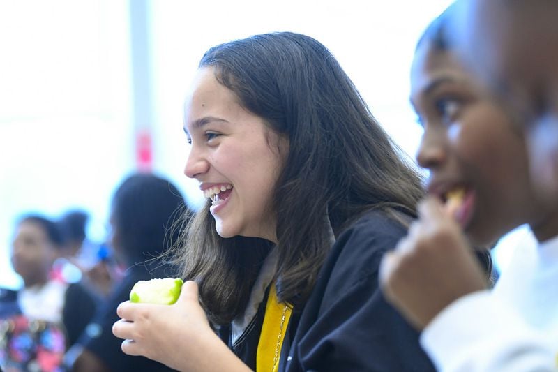 Eighth graders Madison Tetteh, 13, and Destiny Hill, 14, eat lunch in the cafeteria at Elite Scholars Academy in Jonesboro, 2020. 