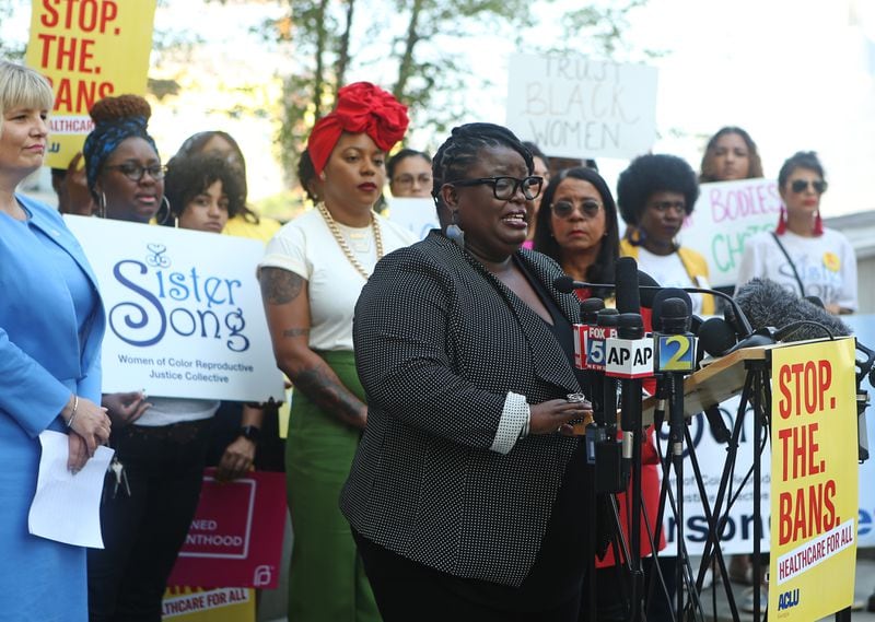 Monica Simpson, executive director of Georgia-based reproductive justice organization SisterSong, has been named to Time magazine’s list of the “100 Most Influential People of 2023.” She is pictured at a microphone in 2019. (Christina Matacotta for the AJC)