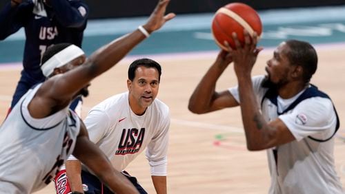 United State's Kevin Durant, right, shoots as Bam Adebayo, left, defends while assistant coach Erik Spoelstra watches during men's basketball practice at the 2024 Summer Olympics, Wednesday, July 24, 2024, in Villeneuve-d'Ascq, France. (AP Photo/Mark J. Terrill)