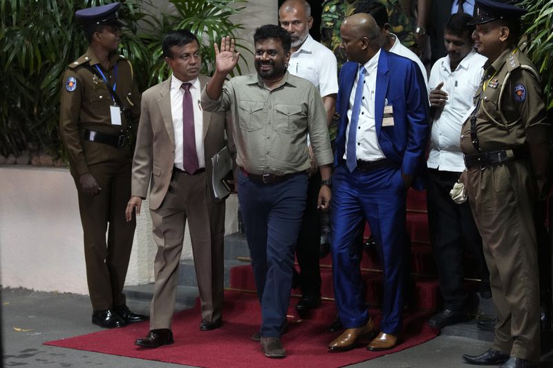 FILE -Marxist lawmaker Anura Kumara Dissanayake waves as he departs the election commission office after winning the Sri Lankan presidential election in Colombo, Sri Lanka, Sept. 22, 2024. (AP Photo/Eranga Jayawardena), File)