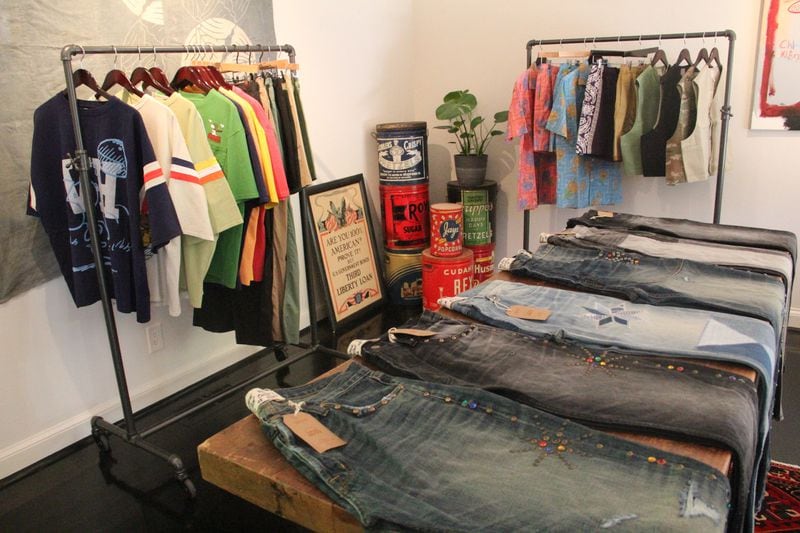 A shot of the showroom inside The Heavy Market's new E Shadowlawn Avenue location where high-quality denim is displayed on a central table.