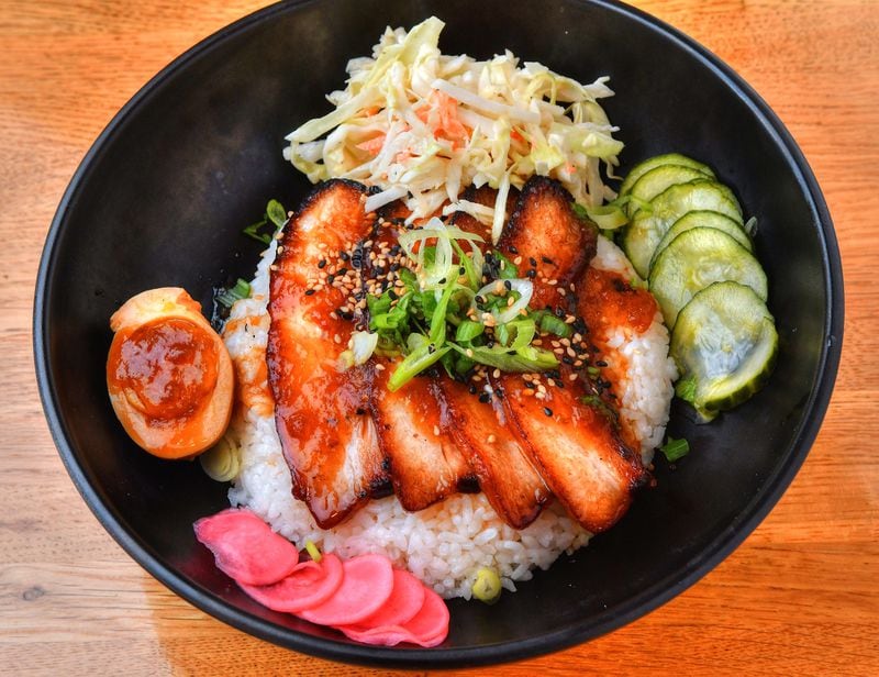 Tenya Rice Bowl topped with 24-hour Braised Pork Chasyu, scallion, pickled red radish and cucumber sweet soy reduction, Japanese slaw and sesame seeds. (Chris Hunt for The Atlanta Journal-Constitution)