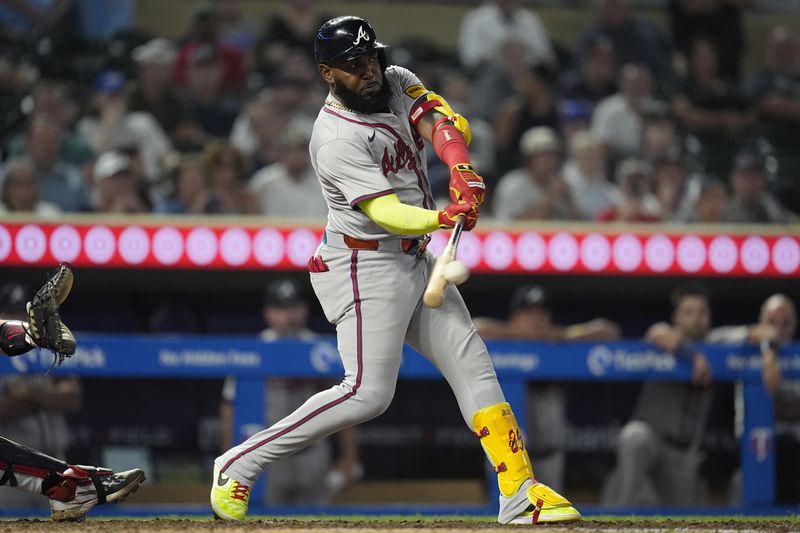 Atlanta Braves designated hitter Marcell Ozuna hits a double during the 10th inning of a baseball game against the Minnesota Twins, Tuesday, Aug. 27, 2024, in Minneapolis. (AP Photo/Abbie Parr)