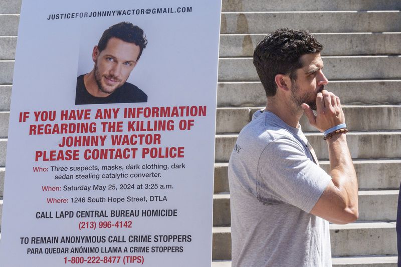 Micah Parker "Vampire Diaries," actor, producer, and organizer of Justice for Johnny Wactor, attends a news conference outside Los Angeles City Hall, in Los Angeles Tuesday, Aug. 13, 2024, asking citizens to help find the suspects that murdered the former "General Hospital" actor pictured. (AP Photo/Damian Dovarganes)