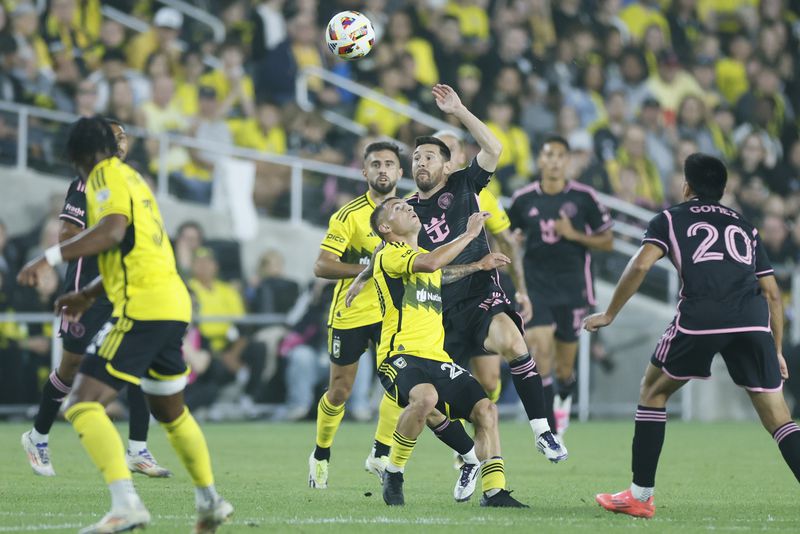 Inter Miami's Lionel Messi, right, and Columbus Crew's Alexandru Matan fight for the ball during the first half of an MLS soccer match Wednesday, Oct. 2, 2024, in Columbus, Ohio. (AP Photo/Jay LaPrete)