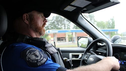 Officer Jacob King drives in his unmarked black Ford Explorer to follow up and build rapport with a resident his unit met. (Photo Courtesy of Madgie Robinson/ Fresh Take Georgia)