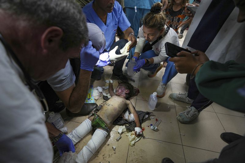 Medics treat a wounded child from an Israeli bombardment of Nuseirat refugee camp, at al-Aqsa Martyrs Hospital in Deir al Balah, central Gaza Strip, Saturday, June 29, 2024. (AP Photo/Abdel Kareem Hana)