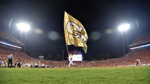 A Georgia Tech cheerleading team member runs with a  Tech flag before the second half at Memorial Stadium on the Clemson University campus in Clemson, S.C. on Thursday, August 29, 2019. Clemson won 52-14 over the Georgia Tech. (Hyosub Shin / Hyosub.Shin@ajc.com)