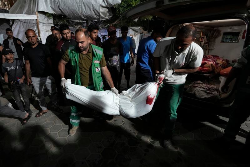 Palestinian medics move bodies killed in the Israeli bombardment of the Gaza Strip to the morgue of Al Aqsa hospital in Deir al Balah, central Gaza Strip, on Sunday, May 26, 2024. (AP Photo/Abdel Kareem Hana)