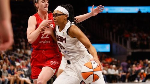 Atlanta Dream guard Allisha Gray (15) dribbles against Indiana Fever guard Caitlin Clark (22) in the first half at State Farm Arena, Monday, August 26, 2024, in Atlanta. The Dream lost 84-79. (Miguel Martinez / AJC)