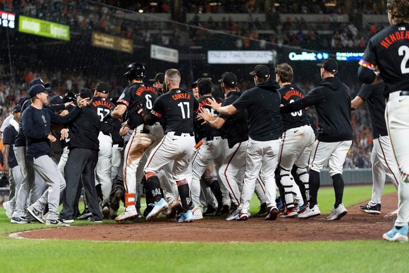 Players clear the benches after Baltimore Orioles' Heston Kjerstad was hit by a pitch from New York Yankees relief pitcher Clay Holmes during the ninth inning of a baseball game, Friday, July 12, 2024, in Baltimore. (AP Photo/Stephanie Scarbrough)