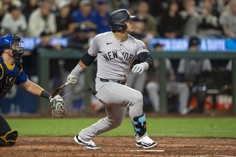 New York Yankees' Jasson Dominguez hits a solo home run during the fifth inning of a baseball game against the Seattle Mariners, Tuesday, Sept. 17, 2024, in Seattle. (AP Photo/Stephen Brashear)