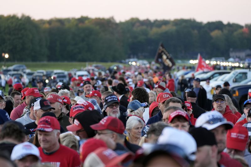 Supporters wait in line before Republican presidential nominee former President Donald Trump speaks at a campaign rally at the Butler Farm Show, the site where a gunman tried to assassinate him in July, Saturday, Oct. 5, 2024, in Butler, Pa. (AP Photo/Alex Brandon)