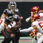 Falcons running back Cordarrelle Patterson runs through Washington Football Team defenders for a first down during the first quarter Sunday, Oct. 3, 2021, at Mercedes-Benz Stadium in Atlanta. (Curtis Compton / Curtis.Compton@ajc.com)