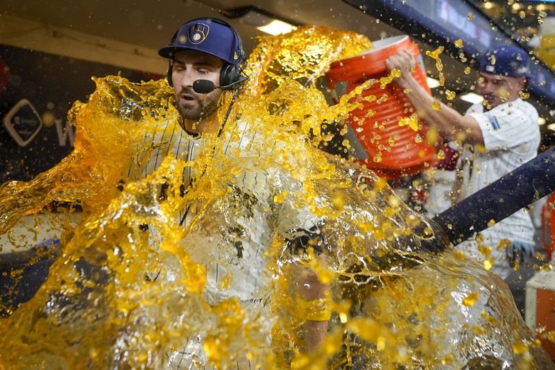 Milwaukee Brewers' Garrett Mitchell is douced by Willy Adames after Game 2 of a National League wild card baseball game against the New York Mets Wednesday, Oct. 2, 2024, in Milwaukee. The Brewers won 5-3 to tie the series 1-1. (AP Photo/Morry Gash)