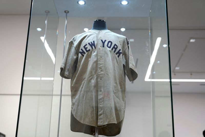 The 1932 Babe Ruth game worn New York Yankees World Series "Called Shot" jersey is displayed in a sealed glass box at Heritage Auction in Irving, Texas, Wednesday, Aug. 21, 2024. (AP Photo/LM Otero)