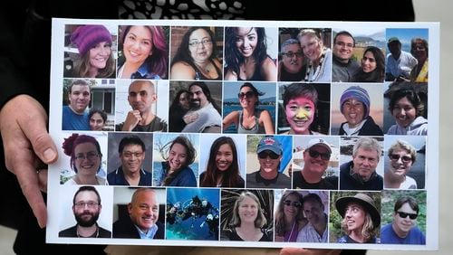 FILE - A photo collage of the victims of the Sept. 2, 2019 fire aboard the dive boat Conception, at Santa Cruz Island, is held by a family member at federal court in Los Angeles, Oct. 25, 2023. Prosecutors are seeking restitution for the families of the 34 people killed in the fire that was the deadliest maritime disaster in recent U.S. history. A judge will determine the amount on Thursday, July 11, 2024, during a hearing in federal court in Los Angeles. (AP Photo/Damian Dovarganes, File)