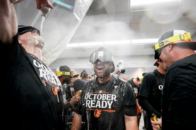 Baltimore Orioles' players celebrate after clinching a playoff berth by defeating the New York Yankees in baseball game, Tuesday, Sept. 24, 2024, in New York. (AP Photo/Bryan Woolston)