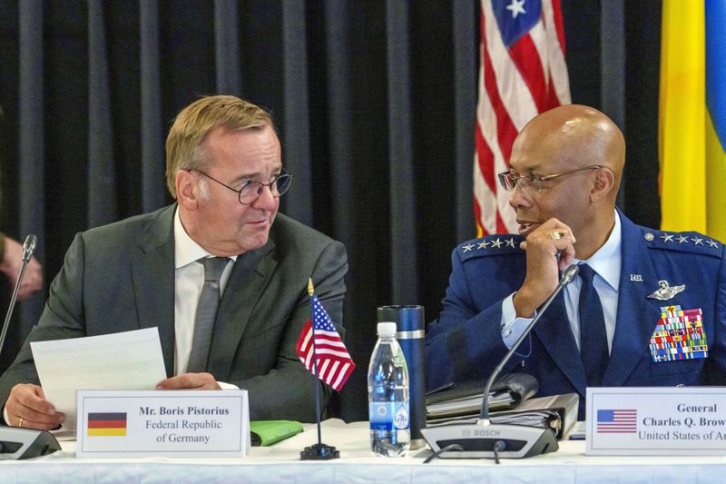 German's Defense Minister Boris Pistorius, left, and Chairman of the Joint Chiefs of Staff Air Force of the U.S. Gen. CQ Brown talk during a meeting with U.S. Defense Secretary Lloyd Austin and Ukraine's President Volodymyr Zelenskyy at Ramstein Air Base in Ramstein-Miesenbach, Germany, Friday, Sept. 6, 2024. (Andreas Arnold/dpa via AP)