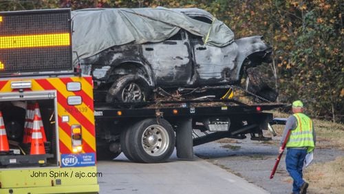 Authorities were on I-75 North in Cherokee County early Tuesday after a vehicle left the interstate and caught fire. The driver and two passengers were found dead.