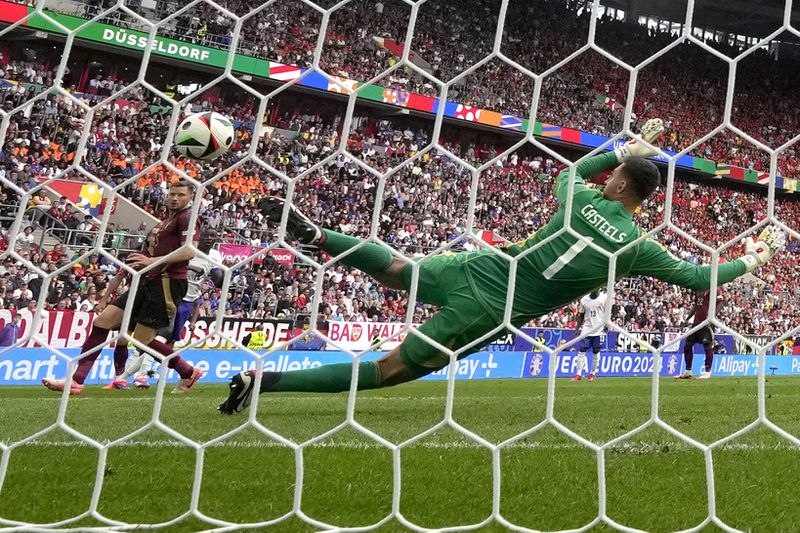 Belgium's Jan Vertonghen, left, scores an own goal during a round of sixteen match between France and Belgium at the Euro 2024 soccer tournament in Duesseldorf, Germany, Monday, July 1, 2024. (AP Photo/Martin Meissner)